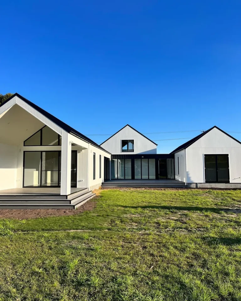 Modern farmhouse with white exterior.