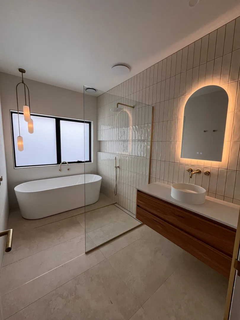 Modern bathroom with bathtub and glass shower.