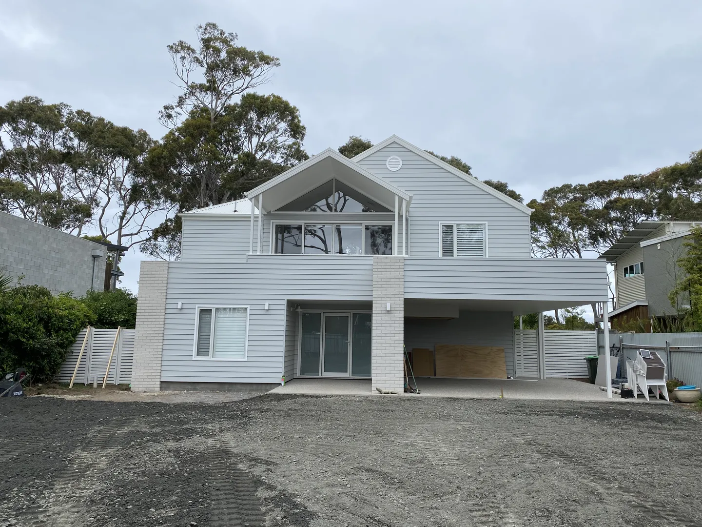 Modern house exterior with trees in background.