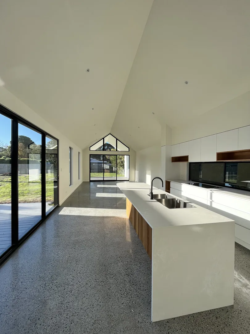 Modern kitchen with large windows and island.