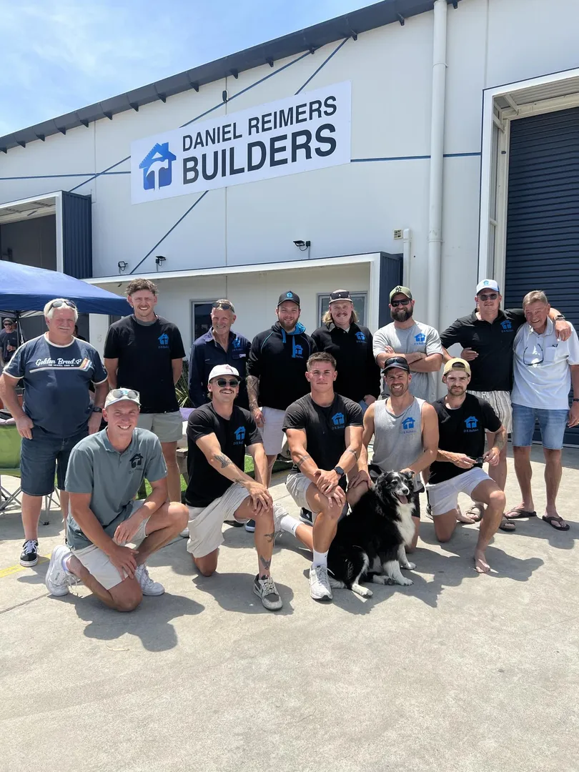 Group of builders outside building company office.